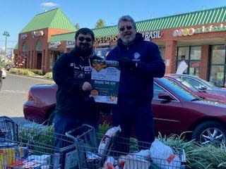 Two Knights of Columbus volunteers lent a hand at last year's Fish Inc. turkey drive outside the Piscataway ShopRite.