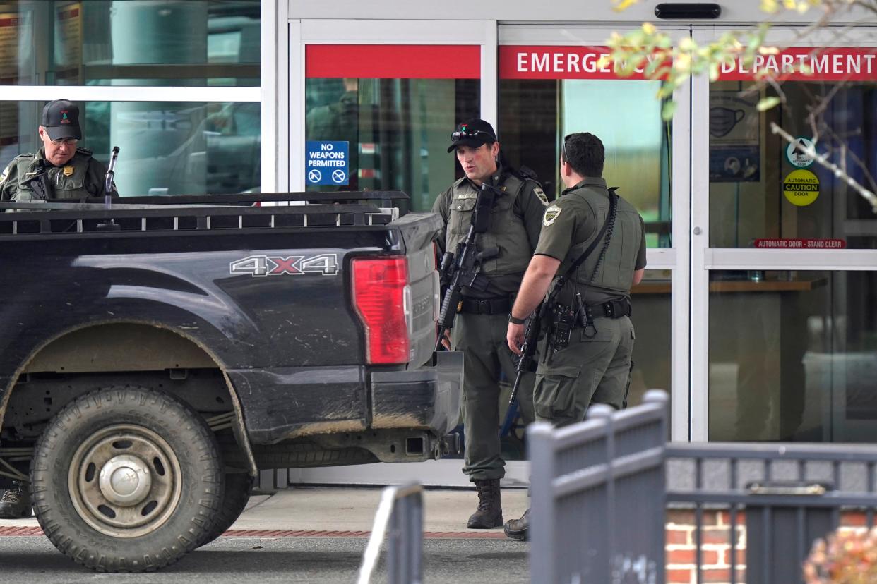 Law enforcement officers carries rifles near an emergency department entrance at Central Maine Medical Center during an active shooter situation, in Lewiston, Maine, Thursday, Oct. 26, 2023.