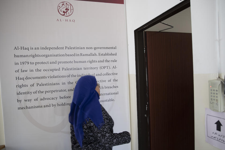 A Palestinian women walks in the al-Haq human rights group organization's offices in the West Bank city of Ramallah, Saturday, Oct. 23, 2021. Israel on Friday, Oct. 22, declared six prominent Palestinian human rights groups to be terrorist organizations, saying they were secretly linked to a left-wing militant movement. It was not immediately clear what the distinction would mean for the groups, most of which also protest rights violations by the Western-backed Palestinian Authority. (AP Photo/Majdi Mohammed)