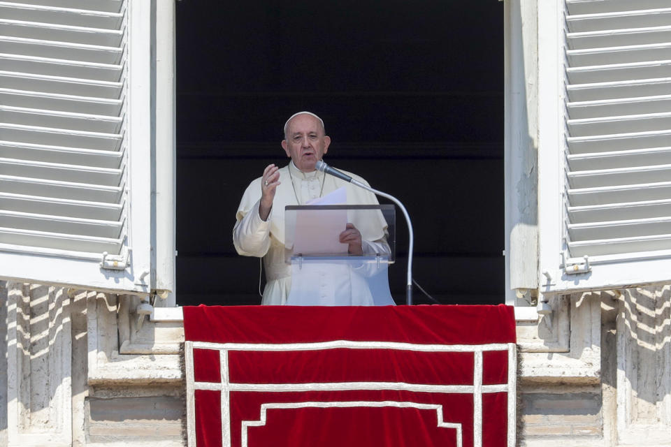 Pope Francis delivers his blessing as he recites the Angelus noon prayer from the window of his studio overlooking St.Peter's Square, at the Vatican, Sunday, Sept. 13, 2020. (AP Photo/Andrew Medichini)