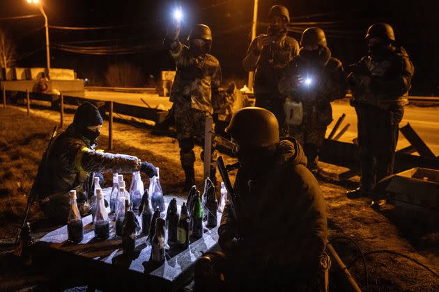 Ukrainian soldiers play checkers with Molotov cocktails in Kyiv. (Photo: Chris McGrath via Getty Images)