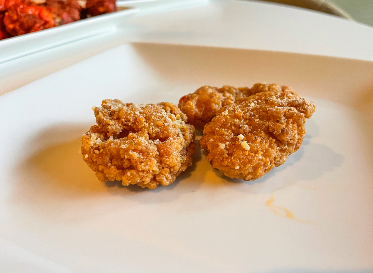 two garlic parm wings on a plate. 