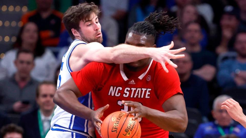 Duke’s Ryan Young (15) defends N.C. State’s DJ Burns Jr. (30) during the first half of N.C. State’s game against Duke in the quarterfinal round of the 2024 ACC Men’s Basketball Tournament at Capital One Arena in Washington, D.C., Thursday, March 14, 2024. Ethan Hyman/ehyman@newsobserver.com
