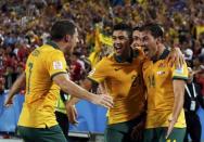 Australia's James Troisi (R) celebrates with teammates after scoring a goal against South Korea during extra time of their Asian Cup final soccer match at the Stadium Australia in Sydney January 31, 2015. REUTERS/Jason Reed