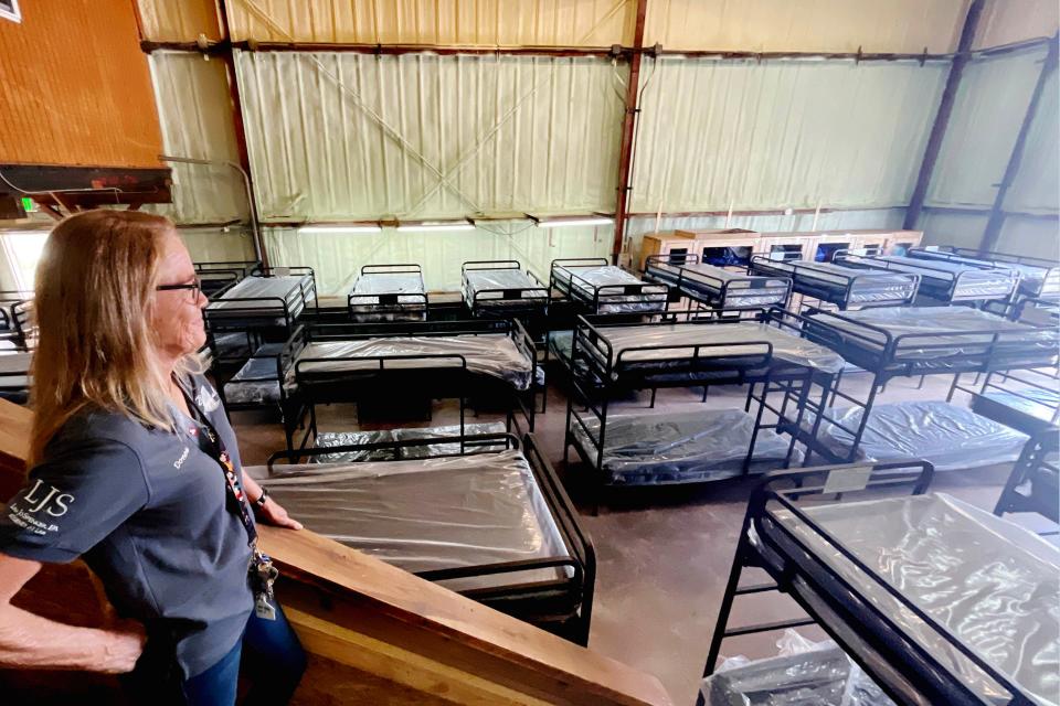 Donna Morgan, shelter manager at One Hopeful Place, looks out on the new 48-bed cold night shelter during an open house held on Wednesday.