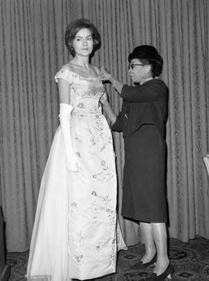 Anne Lowe adjusting the bodice of a gown she designed and worn by Alice Baker, has fitted most of the debutant and wedding dresses of the nation's top families  which include Jackie Kennedy.