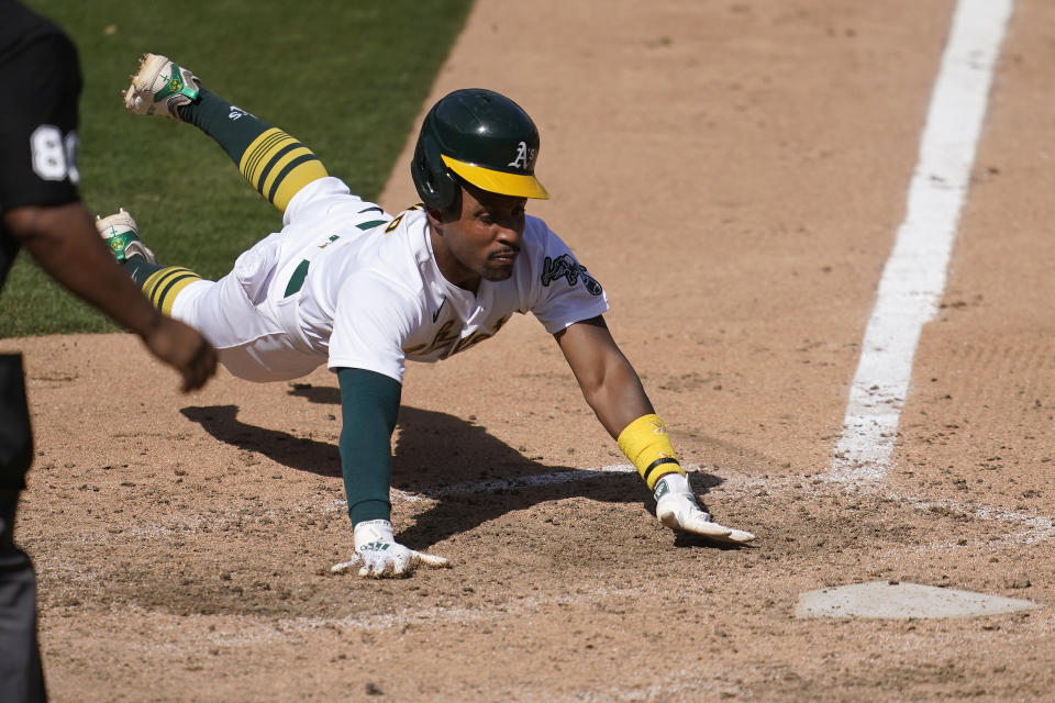 Oakland Athletics' Tony Kemp slides home to score against the Seattle Mariners during the seventh inning of a baseball game in Oakland, Calif., Sunday, Sept. 27, 2020. (AP Photo/Jeff Chiu)