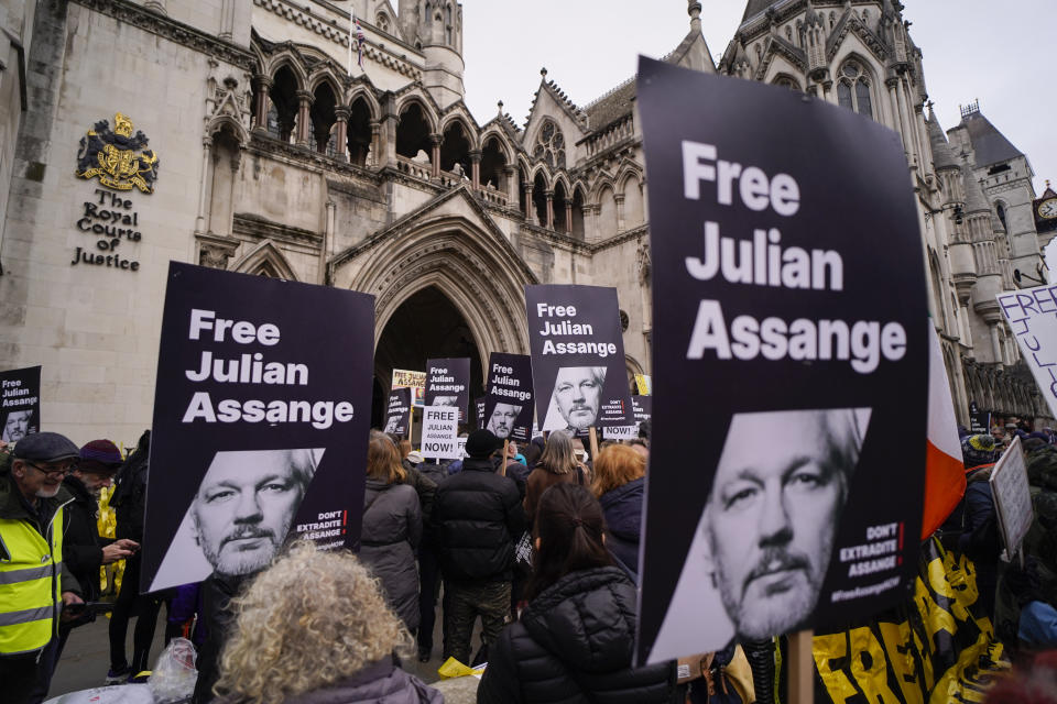 Demonstrators hold banners and placards outside the Royal Courts of Justice in London, Tuesday, Feb. 20, 2024. Julian Assange’s lawyers will begin their final U.K. legal challenge to stop the WikiLeaks founder from being sent to the United States to face spying charges. The 52-year-old has been fighting extradition for more than a decade, including seven years in self-exile in the Ecuadorian Embassy in London and the last five years in a high-security prison. (AP Photo/Alberto Pezzali)