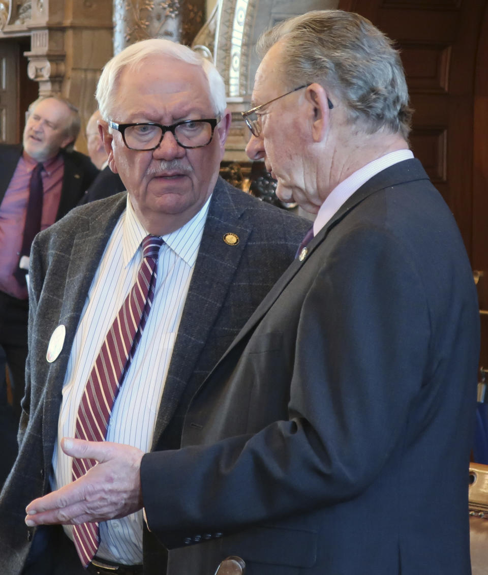In this Wednesday, Feb. 20, 2019 photo, Kansas state Sens. Rick Wilborn, left, R-McPherson, and Dan Goddard, right, R-Parsons, confer during a debate on a bill allowing the Kansas Farm Bureau to provide health coverage for its members, at the Statehouse in Topeka, Kan. Both senators support the bill, which allows the Farm Bureau to offer the coverage without complying with federal Affordable Care Act mandates. (AP Photo/John Hanna)