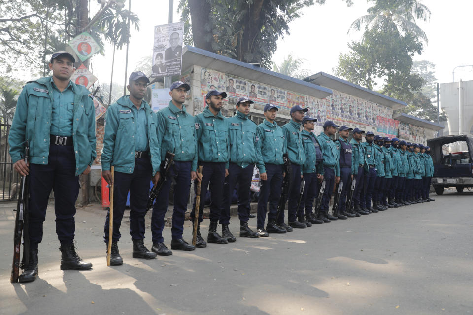 Bangladesh Police stand in front of the National Press Club ahead of elections in Dhaka, Bangladesh, Friday, Jan. 5, 2024. Bangladesh’s main opposition party called for general strikes on the weekend of the country's parliamentary election, urging voters to join its boycott. This year, ballot stations are opening amid an increasingly polarized political culture led by two powerful women; current Prime Minister Sheikh Hasina and opposition leader and former premier Khaleda Zia. (AP Photo/Mahmud Hossain Opu)