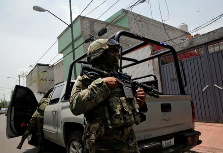 Mexican marine soldiers stand guard outside a house after suspected gang members were killed on Thursday in a gun battle with Mexican marines in Mexico City, Mexico, July 21, 2017. REUTERS/Henry Romero