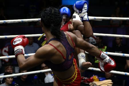 Muay Thai boxer Nong Rose Baan Charoensuk, who is transgender, kicks Priewpak Sorjor Wichit-Padrew during a boxing match at the Rajadamnern Stadium in Bangkok, Thailand, July 13, 2017. REUTERS/Athit Perawongmetha