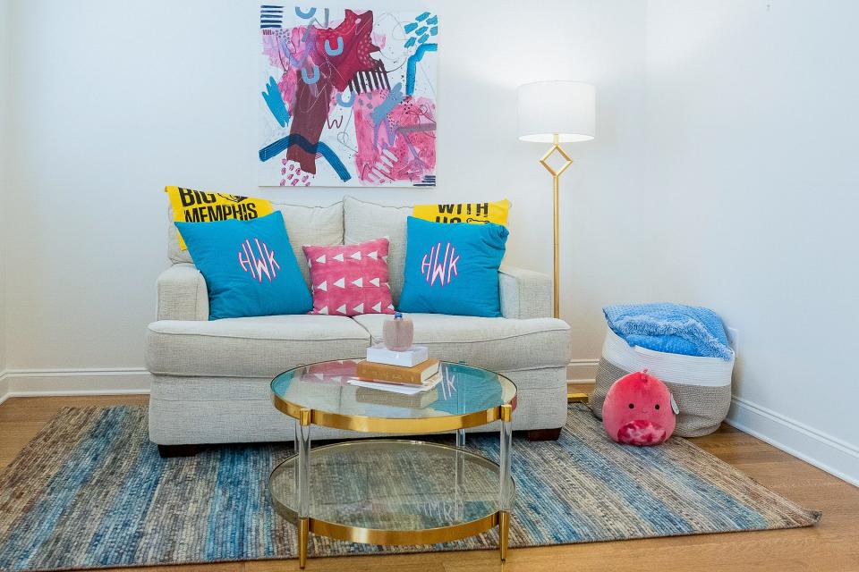 This comfortable seating area that features colorful textiles and art serves as a teen retreat.