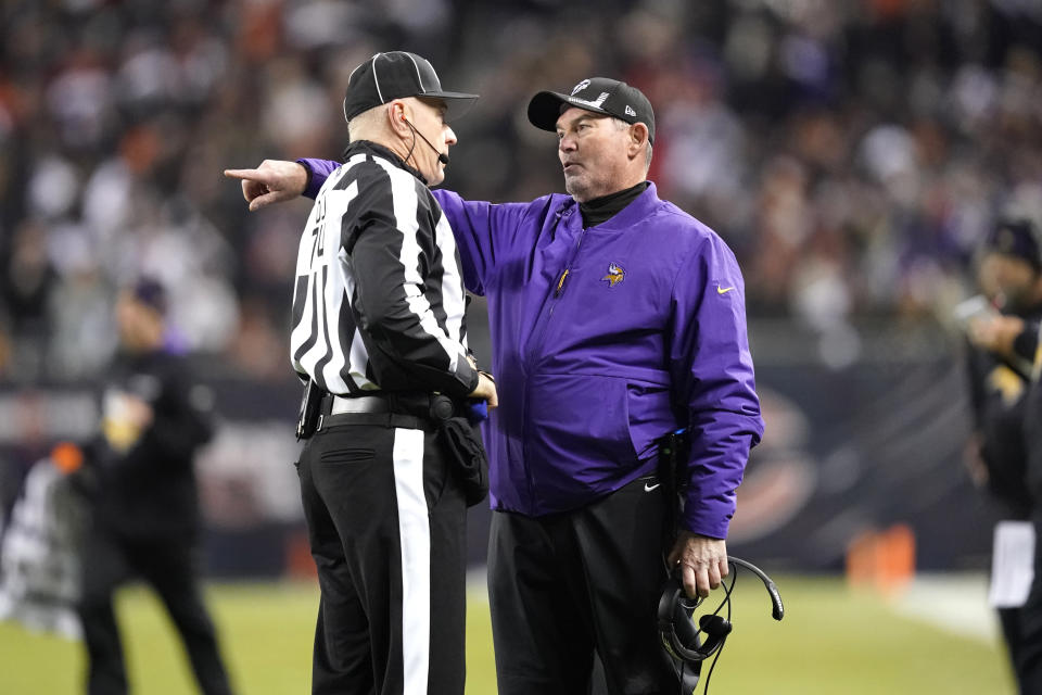 Minnesota Vikings head coach Mike Zimmer, right, talks with down judge Derick Bowers (74) during the first half of an NFL football game against the Chicago Bears Monday, Dec. 20, 2021, in Chicago. (AP Photo/David Banks)