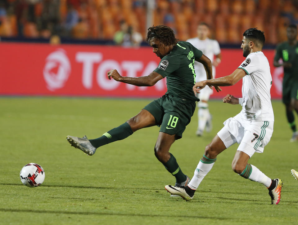 Nigeria's Alexander Iwobi shoots by Algeria's Riyad Mahrez during the African Cup of Nations semifinal soccer match between Algeria and Nigeria in Cairo International stadium in Cairo, Egypt, Sunday, July 14, 2019. (AP Photo/Amr Nabil)