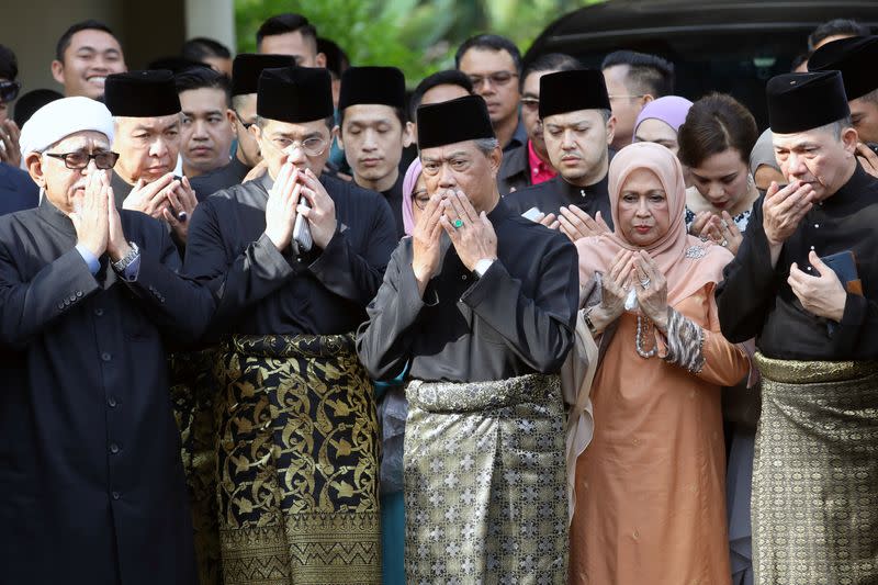 Malaysia's Prime Minister Designate and former interior minister Muhyiddin Yassin prays with his supporters before his inauguration as the 8th prime minister, outside his residence in Kuala Lumpur,
