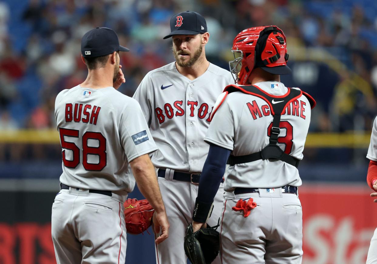 Boston Red Sox pitching coach Dave Bush (58) comes to the mound to talk with starting pitcher Chris Sale (41) and catcher Reese McGuire (3) against the Tampa Bay Rays during the first inning at Tropicana Field on April 12, 2023.