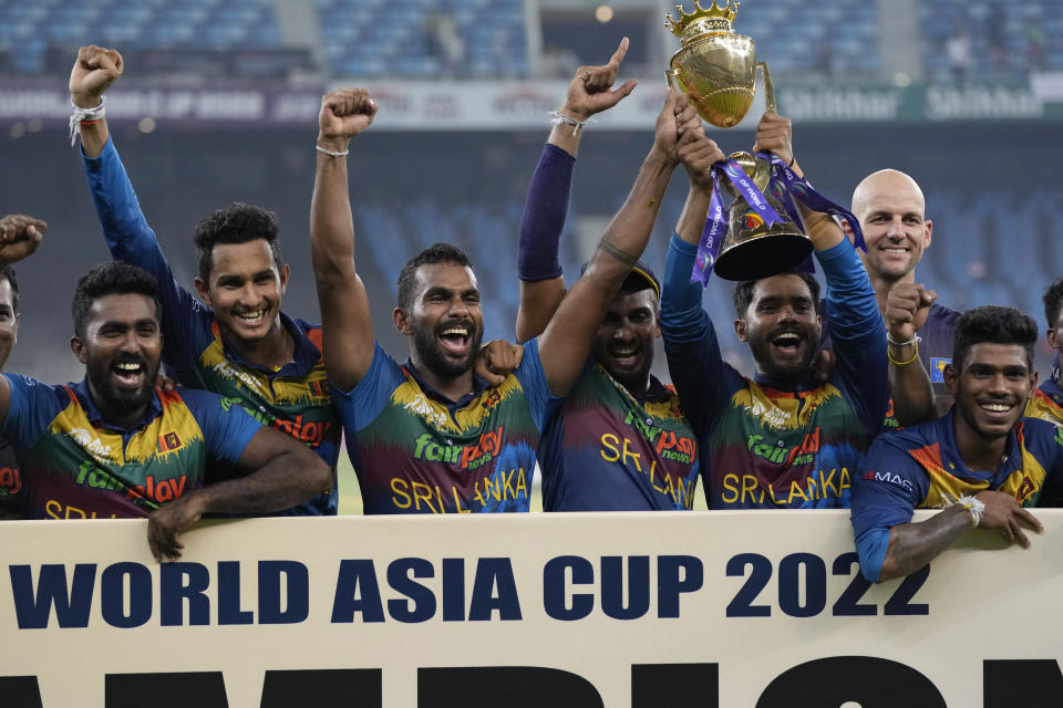 Sri Lankan players celebrate with the winners trophy after their win in the T20 cricket Asia Cup final match against Pakistan, in Dubai, United Arab Emirates, Sunday, Sept. 11, 2022. (AP Photo/Anjum Naveed)