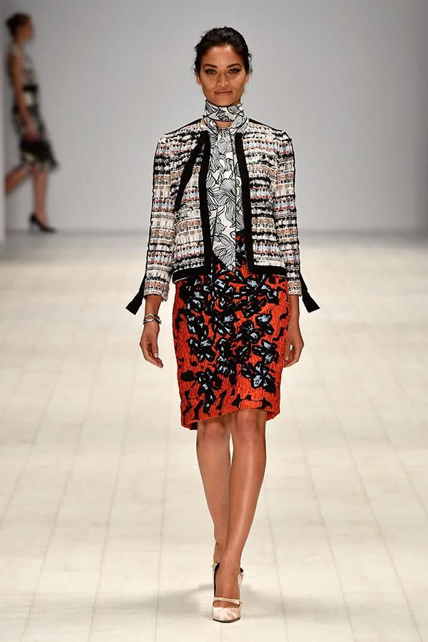 Shanina opened the show in this vibrant orange mini skirt, ruffled shirt and tweed jacket.