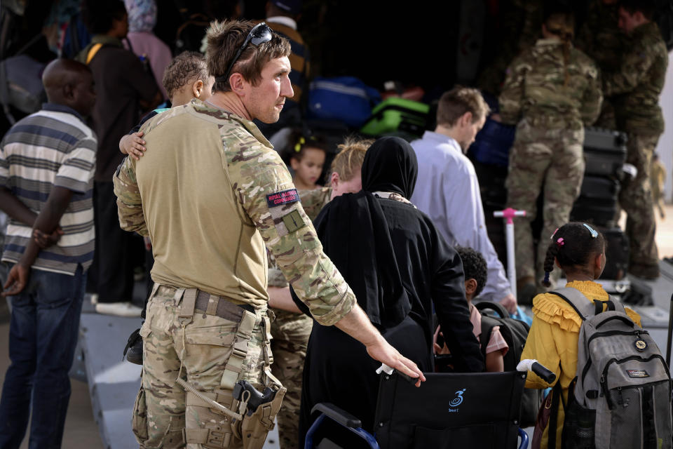 In this handout image provided by the UK Ministry of Defence, on Thursday, April 27, 2023, British Nationals board an RAF aircraft for evacuation of civilians to Larnaca International Airport in Cyprus, at Wadi Seidna military airport, 22 kilometres (14 mi) north of Khartoum, Sudan. The UK government assisted by the British Military has evacuated British Citizens from Sudan. RAF flights are continuing between Wadi Seidna airport in Sudan to Larnaca International Airport, following three evacuation flights that took place late overnight between Tuesday 25 April and Wednesday 26 April. (PO Phot Aaron Hoare/UK Ministry of Defence via AP)