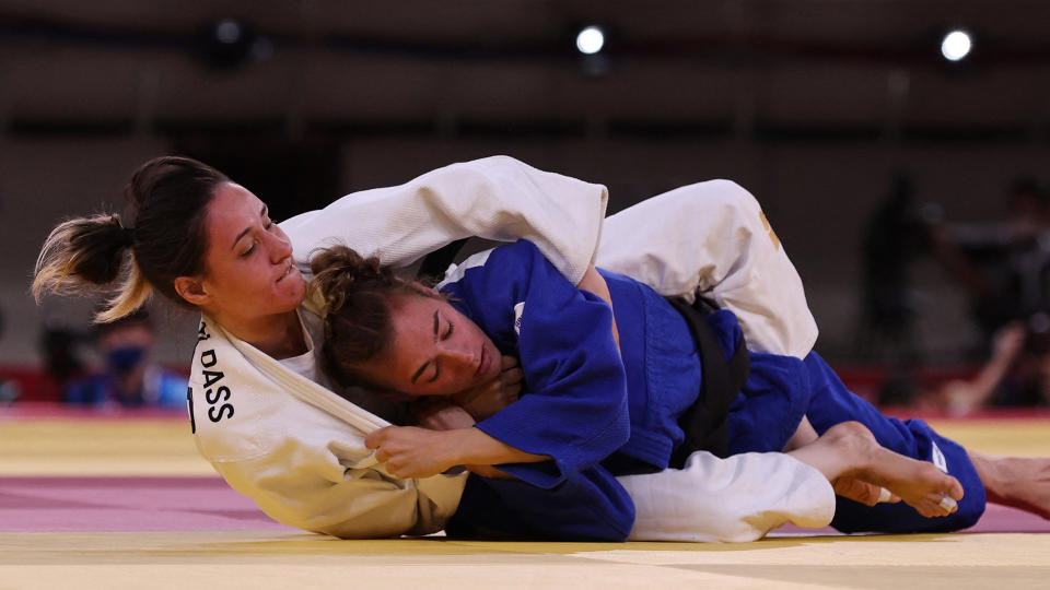 Refugee Olympic Team's Sanda Aldass (white) fights Serbia's Marica Perisic. (Photo by JACK GUEZ/AFP via Getty Images)