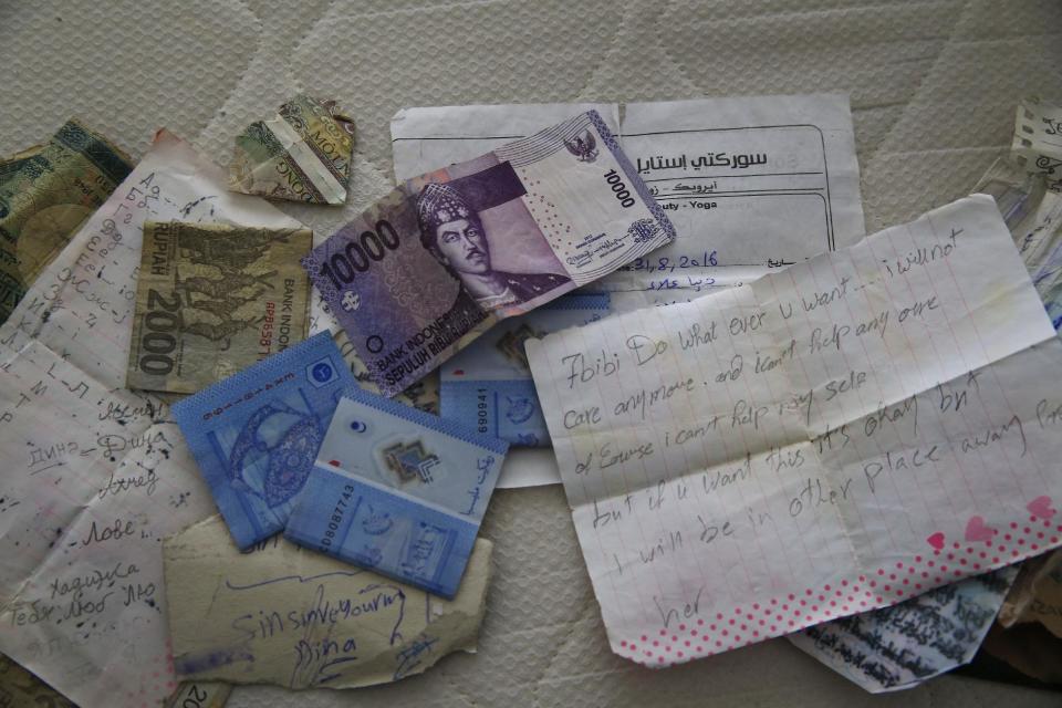 Belongings including banknotes of different currencies are pictured on a bed inside the flat where a suspect of New Year's Day nightclub attack was arrested during an overnight police raid, in Istanbul, Tuesday, Jan. 17, 2017. Turkish police said they captured the gunman who carried out the deadly New Year's nightclub attack in Istanbul, with officials saying Tuesday that he's an Uzbekistan national who trained in Afghanistan and confessed to the massacre.(AP Photo/Lefteris Pitarakis)