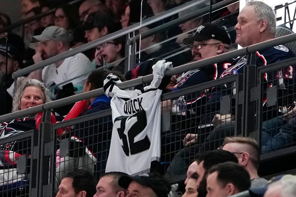 A fan hangs a Jonathan Quick jersey in front of his seat during Friday's game. Quick was traded to the Blue Jackets this week before being traded away a day later.