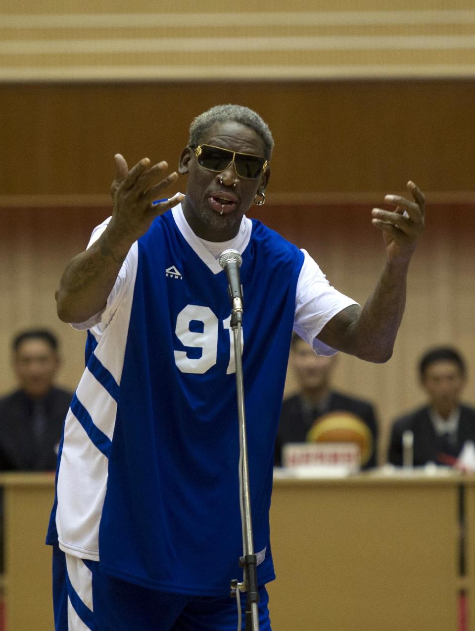 El basquetbolista Dennis Rodman canta "Feliz cumpleaños" al líder norcoreano Kim Jong Un, sentado en las gradas, antes de un partido de exhibición de básquetbol en un estadio techado en Pyongyang, Corea del Norte, el miércoles 8 de enero de 2014. (Foto AP/Kim Kwang Hyon)