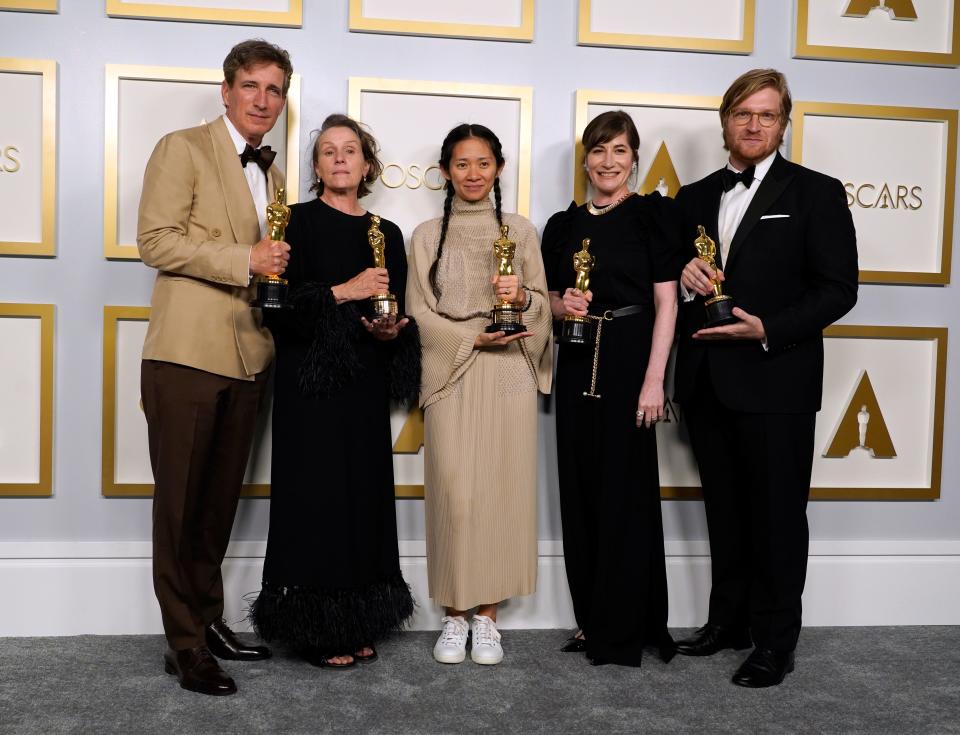 Producers Peter Spears, from left, Frances McDormand, Chloe Zhao, Mollye Asher and Dan Janvey, winners of the award for best picture for "Nomadland."