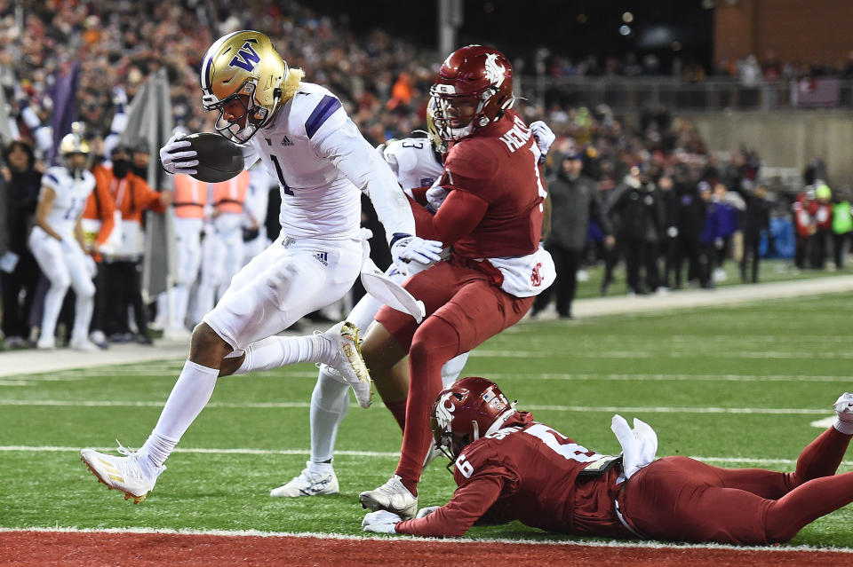 Nov 26, 2022; Pullman, Washington, USA; Washington Huskies wide receiver Rome Odunze (1) jumps into he end zone for a touchdown against Washington State Cougars defensive back Chau Smith-Wade (6) in the second half at Gesa Field at Martin Stadium. Washington won 51-33. Mandatory Credit: James Snook-USA TODAY Sports