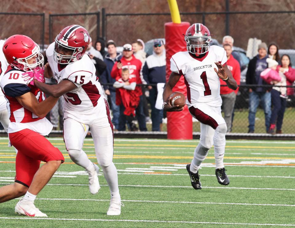 Brockton quarterback Jason Wonodi carries the football during the Thanksgiving Day game against Bridgewater-Raynham on Thursday, Nov. 25, 2021.