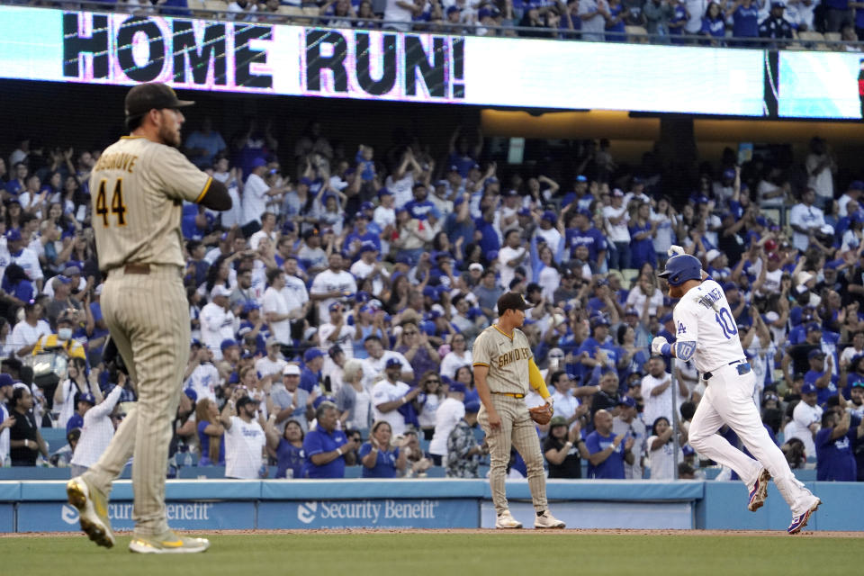 Los Angeles Dodgers' Justin Turner, right, rounds third after hitting a solo home run as San Diego Padres starting pitcher Joe Musgrove, left, watches along with third baseman Ha-Seong Kim during the second inning of a baseball game Thursday, June 30, 2022, in Los Angeles. (AP Photo/Mark J. Terrill)