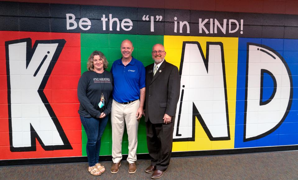 Mary Bryan Elementary Social Worker Shannon Romine, from left, Southport Presbyterian Church Senior Pastor Rob Hock and Mary Bryan Elementary Principal Jack Heath are the “I” in “KIND” at Mary Bryan Elementary School, Friday, Sept. 1, 2023 in the Saint Francis neighborhood. The Perry Township school is in a partnership with Southport Presbyterian Church in the Saint Francis neighborhood.