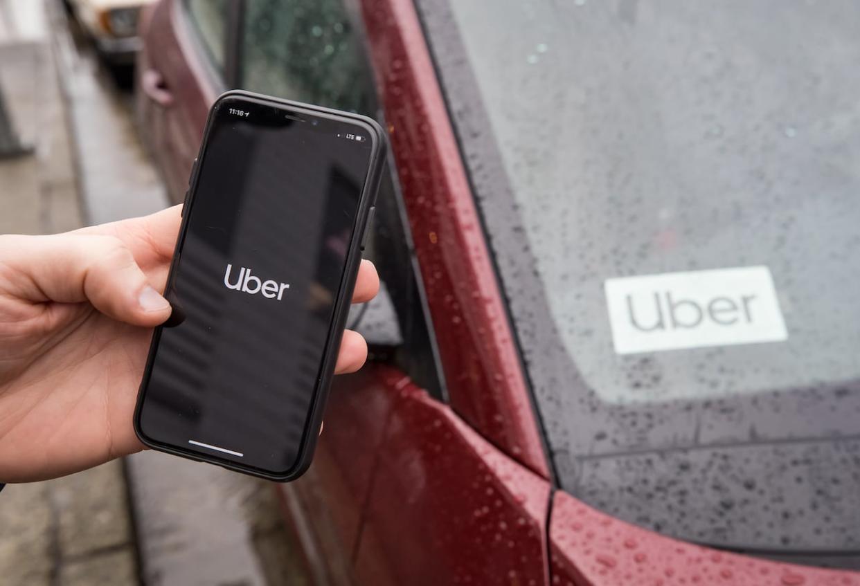 Ride-sharing companies like Uber were charging many times the cost of a normal fare on Monday as a bus strike hit Metro Vancouver. (Darryl Dyck/The Canadian Press - image credit)