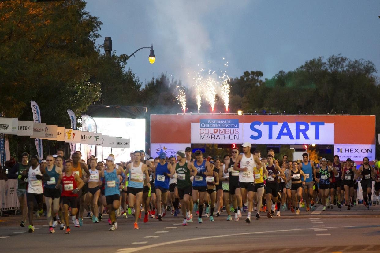 Participants from the 2021 Nationwide Children's Hospital Columbus Marathon take off from the starting line.