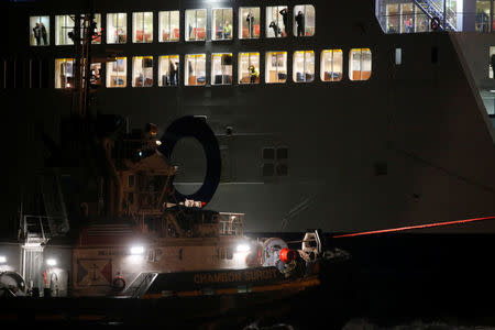 Passengers aboard the P&O ferry Pride of Kent watch rescue operations after the vessel ran aground during bad weather in the port of Calais in northern France, December 10, 2017. REUTERS/Pascal Rossignol