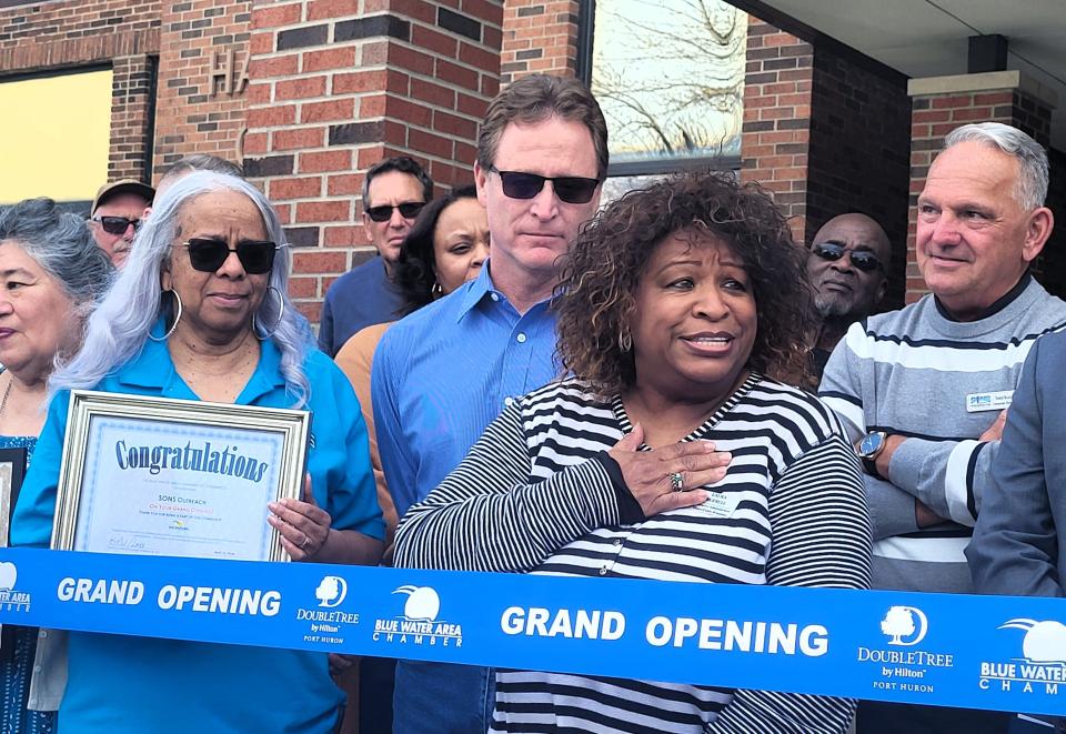 Laura Burrell, of SONS Outreach, right, shares a few emotional remarks on Tuesday, April 16, 2024, during a gathering to celebrate SONS' new resource center in Port Huron.