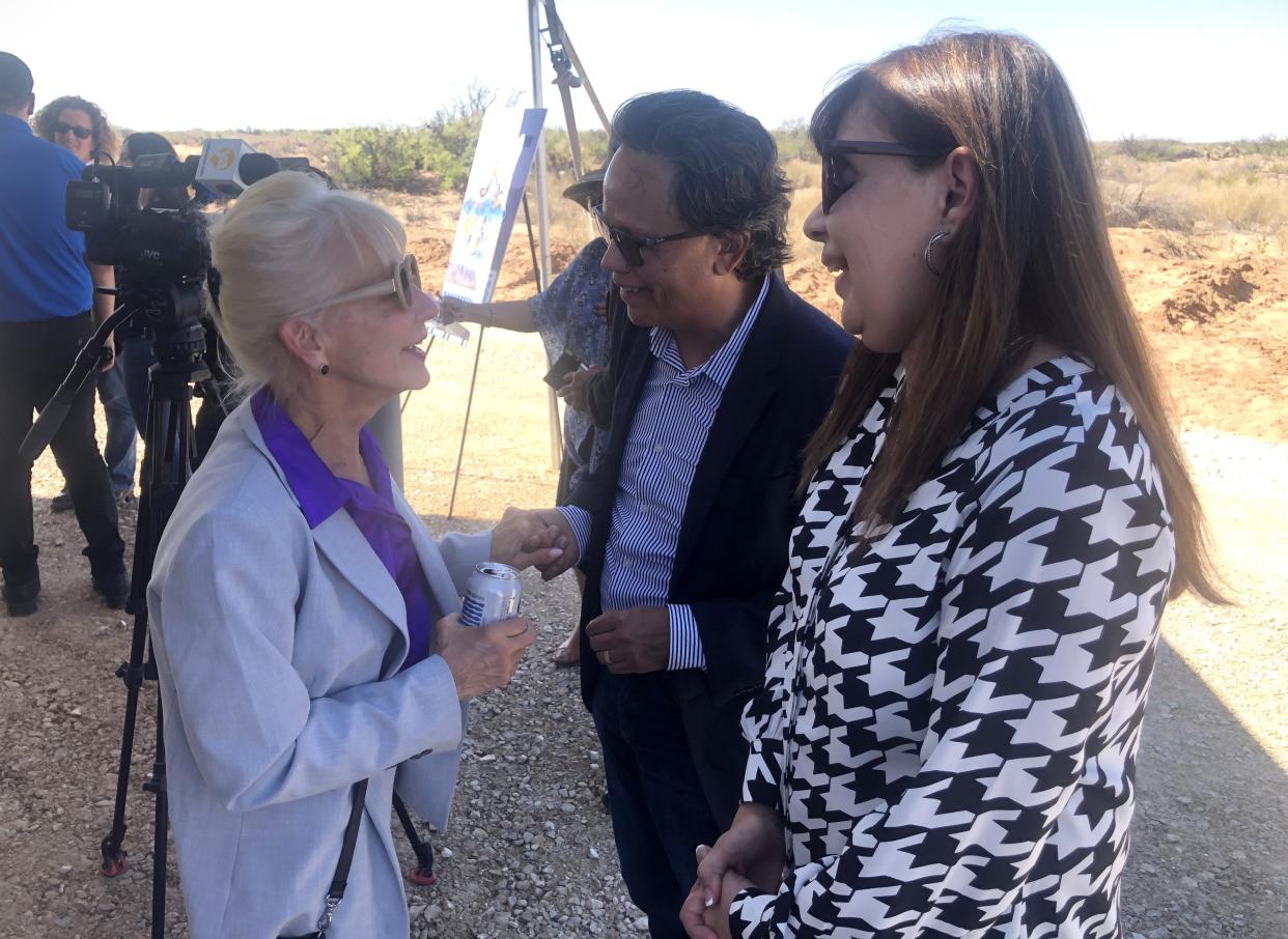 El Paso Electric CEO Kelly Tomblin, left, speaks to Hector Aguilar and his wife, Slyvia Ruvaleaba, owners of about 1,000 acres of land they're leasing for the utility's 150MW Felina Solar Resource plant. They spoke after the Monday groundbreaking ceremony.