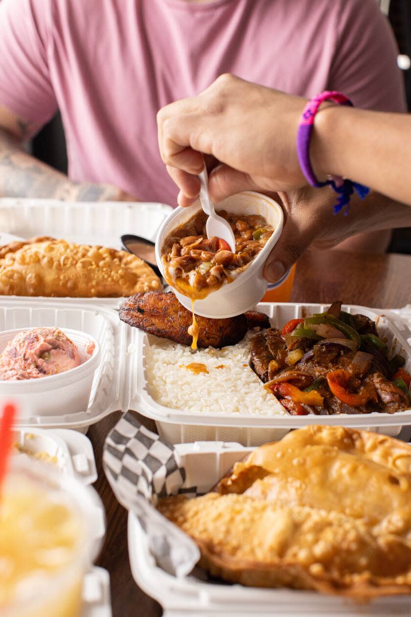 Red beans are poured over white rice with Santana's chicken. 