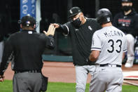 Chicago White Sox manager Rick Renteria, center, is ejected from a baseball game by umpire Dan Bellino for arguing after James McCann (33) was called out on strikes during the ninth inning Monday, Sept. 21, 2020, in Cleveland. (AP Photo/Ron Schwane)