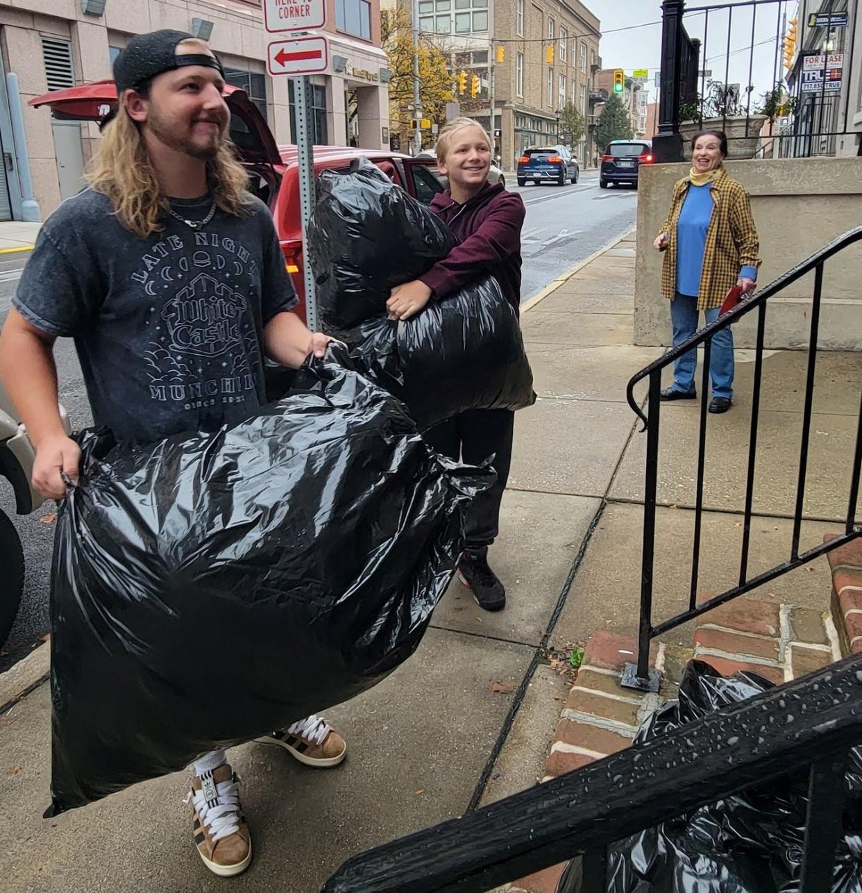 Tristan, left, and Emerson Rankin deliver bags of coats to Next Door in York on Nov. 5, 2023.