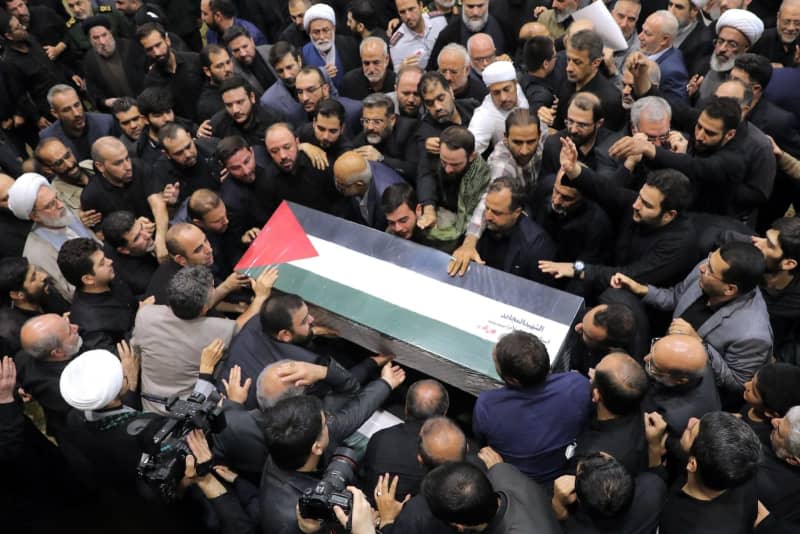 People carry the coffin of Hamas Political leader Ismail Haniyeh, who was assassinated in the Iranian Capital, during his funeral ceremony at Tehran University in Tehran. Iranian Supreme Leader's Office/ZUMA Press Wire/dpa