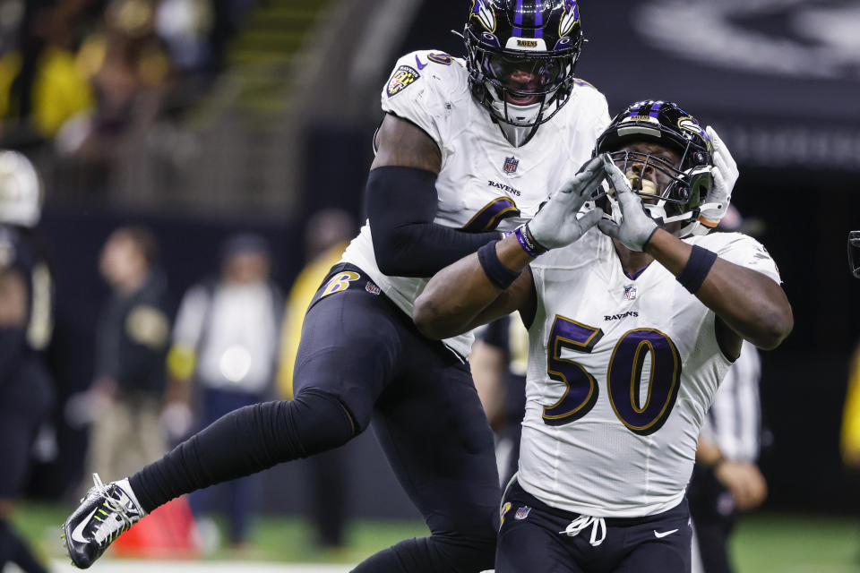 Baltimore Ravens linebackers Patrick Queen, left, and Justin Houston celebrate after a sack in the second half of an NFL football game against the New Orleans Saints in New Orleans, Monday, Nov. 7, 2022. (AP Photo/Butch Dill)