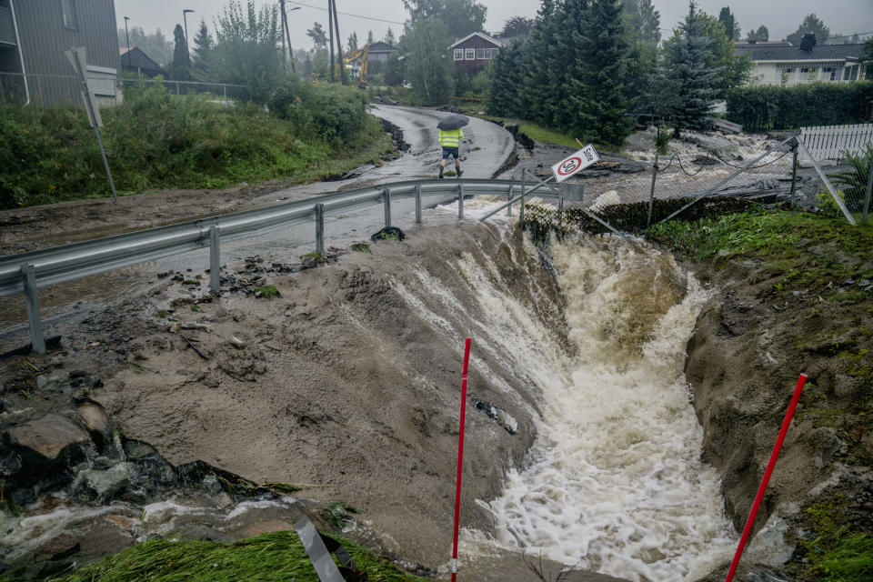 A view of a stream overflowing its banks, in Gran, Norway, Tuesday, Aug. 8, 2023. Norwegian authorities warned Tuesday to prepare for “extremely heavy rainfall” in the area after Storm Hans caused injuries, ripped off roofs and upended summertime life in northern Europe. (Stian Lysberg Solum /NTB Scanpix via AP)