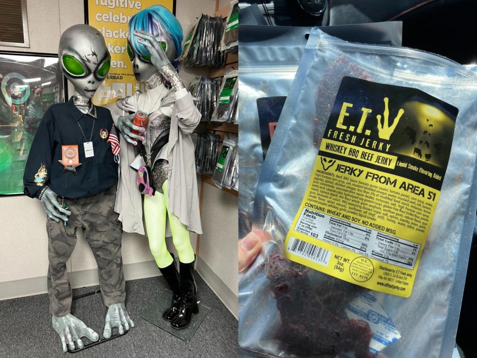 On the left, two life-size alien figures with green eyes and silver skin. On the right, a hand holding a bag of whisky-bbq beef jerky from E.T. Fresh Jerky.