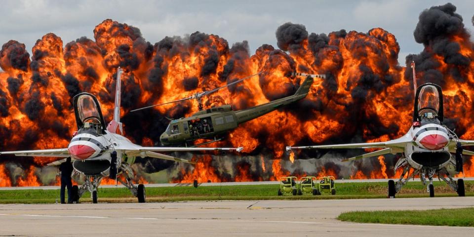 US Air Force Thunderbirds sit on the tarmac while a helicopter picks up a downed pilot amid pyrotechnics simulation during a Vietnam War reenactment at the Sioux Falls Airshow in South Dakota in August 2019.