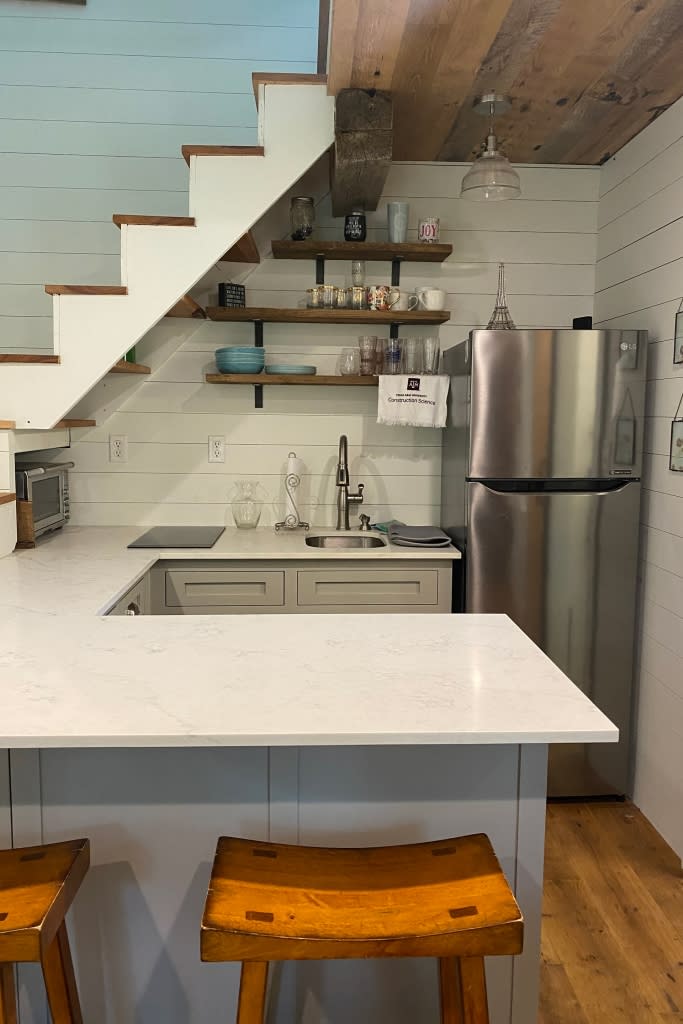 Matson’s kitchen and dining area underneath stairs that lead to her bedroom.