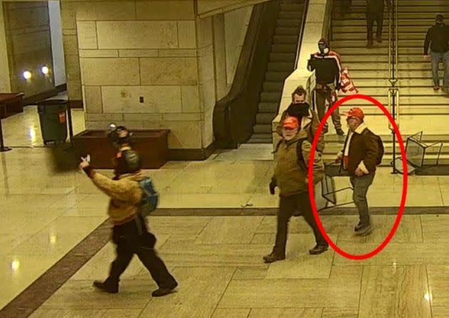 Brad Rukstales grabs a chair during the riot at the U.S. Capitol on Jan. 6. (Photo: U.S. Attorney's Office)