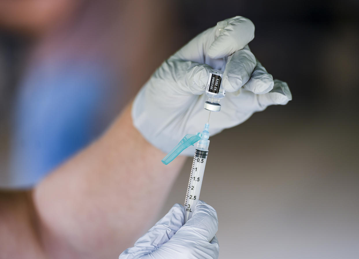 A nurse fills a syringe with a dose of BioNTech, Pfizer COVID-19 vaccine in Reading, Penn.