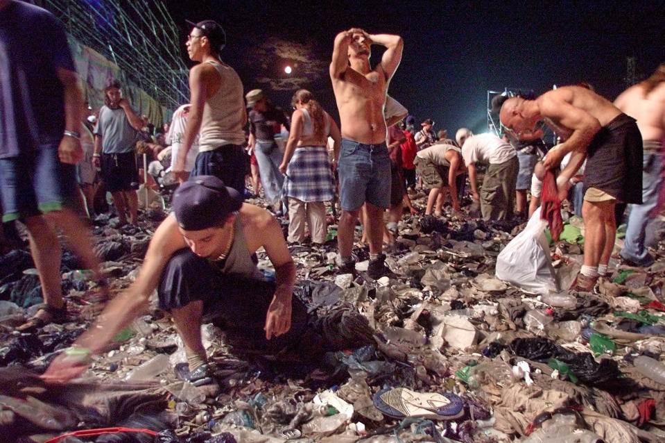 people on the ground cleaning up all the litter